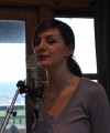 Laura singing into a microphone. - © 2010 Sam Carroll